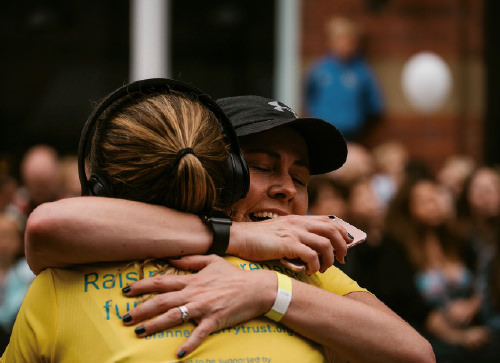 Runners hugging wearing Dianne Oxberry Trust t-shirts